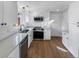 Renovated kitchen featuring white cabinets, stainless appliances, and quartz countertops at 1479 S Bellaire St, Denver, CO 80222
