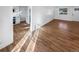 Bright living room featuring hardwood floors, white walls, and a large window for natural light at 1479 S Bellaire St, Denver, CO 80222