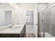 Bathroom features a dual vanity, large mirror, and glass-enclosed shower at 1595 Orchard St, Brighton, CO 80601