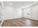 Clean, bright room with wood-look floors and a single window offering natural light at 1595 Orchard St, Brighton, CO 80601