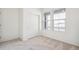 Carpeted room with window and double closet, providing ample space and storage at 1595 Orchard St, Brighton, CO 80601