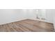 Clean, bright room with wood-look floors and french doors at 1595 Orchard St, Brighton, CO 80601