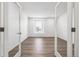 Bright room with wood-look floors framed by glass french doors and a large window at 1595 Orchard St, Brighton, CO 80601