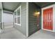 Covered entryway featuring a vibrant front door, side porch, and exterior lighting at 1595 Orchard St, Brighton, CO 80601