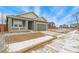 View of the single Gathering home, featuring a front porch and two car garage at 1595 Orchard St, Brighton, CO 80601