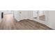 Hallway features wood-look floors and white doors with silver hardware at 1595 Orchard St, Brighton, CO 80601