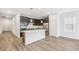 Spacious kitchen features wood-look floors, stainless appliances and large island at 1595 Orchard St, Brighton, CO 80601