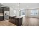 Kitchen with island, stainless refrigerator, and sliding glass door to backyard at 1595 Orchard St, Brighton, CO 80601
