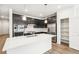 Spacious kitchen features black cabinetry, stainless appliances, and large island at 1595 Orchard St, Brighton, CO 80601