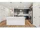 Spacious kitchen features black cabinetry, stainless appliances, and quartz island at 1595 Orchard St, Brighton, CO 80601