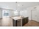 Kitchen with island, stainless dishwasher, and sliding glass door to backyard at 1595 Orchard St, Brighton, CO 80601