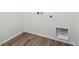 Convenient laundry area featuring modern wood-look flooring at 1595 Orchard St, Brighton, CO 80601