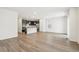 Open-concept living space featuring wood flooring and modern kitchen with stainless appliances at 1595 Orchard St, Brighton, CO 80601