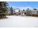 Spacious backyard featuring a covered patio, perfect for outdoor entertaining and relaxation during warm summer days at 9810 Venneford Ranch Rd, Highlands Ranch, CO 80126