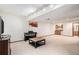 Finished basement with a kitchenette, a music area, and neutral carpet at 9810 Venneford Ranch Rd, Highlands Ranch, CO 80126