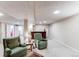 Finished basement with two armchairs, a small table, and a bar area for entertaining and relaxation at 20855 E Lyttle Dr, Parker, CO 80138