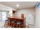 Finished basement with a handsome wooden bar, seating for three, and a classic Admiral refrigerator at 20855 E Lyttle Dr, Parker, CO 80138