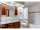 Bathroom with a vanity, toilet, and a shower/tub combo with white tile and a decorative mosaic border at 20855 E Lyttle Dr, Parker, CO 80138