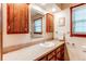 Bathroom featuring a granite countertop, wooden cabinetry, a sink, and a large mirror reflecting natural light from the window at 20855 E Lyttle Dr, Parker, CO 80138