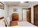Bedroom featuring a bed, dresser, and ensuite bathroom with a ceiling fan, offering a comfortable and private living space at 20855 E Lyttle Dr, Parker, CO 80138