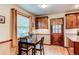 Bright eat-in kitchen area with a table set for four, wooden cabinets, and door to exterior at 20855 E Lyttle Dr, Parker, CO 80138