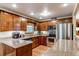 Updated kitchen with stainless steel appliances, granite countertops, and warm wood cabinetry at 20855 E Lyttle Dr, Parker, CO 80138