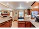 Open kitchen and eat-in area with wood cabinets, granite countertops, and stainless steel appliances at 20855 E Lyttle Dr, Parker, CO 80138
