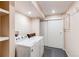 Well-lit laundry room with washer, dryer, shelving for storage, and a minimalist design at 20855 E Lyttle Dr, Parker, CO 80138