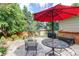 Outdoor patio setting with a table, chairs, a shade umbrella, and a well-maintained backyard at 20855 E Lyttle Dr, Parker, CO 80138