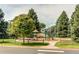Community playground featuring swings, slides, and other play equipment in a park-like setting at 20855 E Lyttle Dr, Parker, CO 80138
