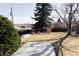 Backyard view from the patio, showing a lawn with mature trees at 3520 Miller St, Wheat Ridge, CO 80033
