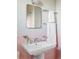 Charming bathroom features a pedestal sink, pink tile, and a bright chrome mirror at 3520 Miller St, Wheat Ridge, CO 80033