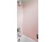 Bathroom area features pink tiling with new showerhead and faucet, offering vintage charm at 3520 Miller St, Wheat Ridge, CO 80033