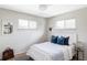 Light bedroom with big windows, plush bedding, and bright, white walls at 3520 Miller St, Wheat Ridge, CO 80033