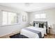 Cozy bedroom boasts hardwood floors, two windows, and modern decor at 3520 Miller St, Wheat Ridge, CO 80033