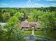 Expansive property showcases a luxurious brick home surrounded by lush greenery and mature trees at 5196 S Williams Dr, Greenwood Village, CO 80121