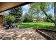 Inviting patio with an expansive, well-manicured backyard and mature trees offering shade and privacy at 5196 S Williams Dr, Greenwood Village, CO 80121