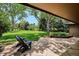 Relaxing backyard patio featuring comfortable seating and views of the lush green lawn and mature trees at 5196 S Williams Dr, Greenwood Village, CO 80121