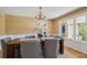 Bright dining area with decorative lighting fixture, neutral wall coverings, and backyard views from a double window at 5196 S Williams Dr, Greenwood Village, CO 80121