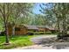 Charming brick home with lush green lawn and mature trees creating a private and serene atmosphere at 5196 S Williams Dr, Greenwood Village, CO 80121