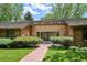 Inviting front entrance with brick pathway and manicured landscaping leading to double doors at 5196 S Williams Dr, Greenwood Village, CO 80121