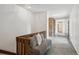 Inviting hallway with tile flooring, complemented by a cozy seating area and exposed brick accents at 5196 S Williams Dr, Greenwood Village, CO 80121