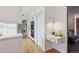 Open-concept kitchen featuring sleek white cabinetry and modern appliances leading to a comfortable living space at 5196 S Williams Dr, Greenwood Village, CO 80121