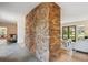 Spacious living room featuring a stone wall, hardwood floors, and large windows for natural light at 5196 S Williams Dr, Greenwood Village, CO 80121