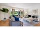 Bright and airy living room with French doors opening to a lush backyard, offering seamless indoor-outdoor living at 5196 S Williams Dr, Greenwood Village, CO 80121