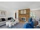 Cozy living room with a brick fireplace, plush seating, and stylish decor for relaxation and comfort at 5196 S Williams Dr, Greenwood Village, CO 80121