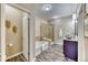 Well-lit bathroom with a soaking tub, a walk-in shower, granite countertop vanity with modern bowl sink at 31101 Black Eagle Dr # 202, Evergreen, CO 80439