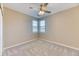 Well-lit bedroom featuring carpeted floors, neutral paint, a ceiling fan, and a window with blinds at 31101 Black Eagle Dr # 202, Evergreen, CO 80439