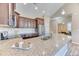 Well-lit kitchen with stainless steel appliances and granite countertops with seating area at 31101 Black Eagle Dr # 202, Evergreen, CO 80439