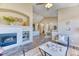 Open-concept living room showcasing a fireplace, hardwood floors, and seamless flow to other rooms at 31101 Black Eagle Dr # 202, Evergreen, CO 80439